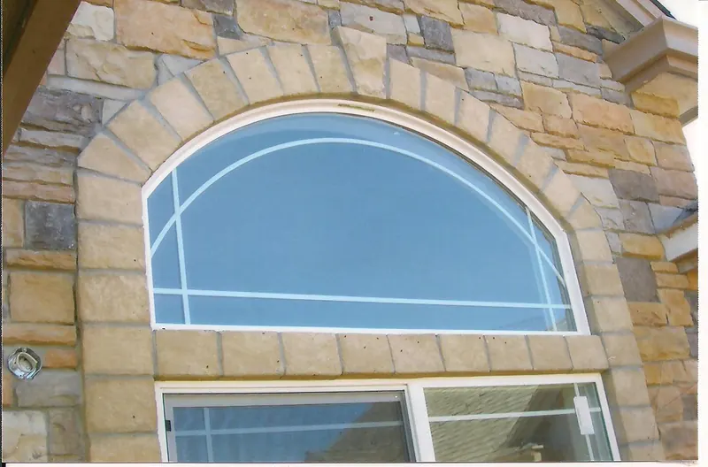 Cut stone arch window surround by Brickhouse Masonry, Central Valley CA