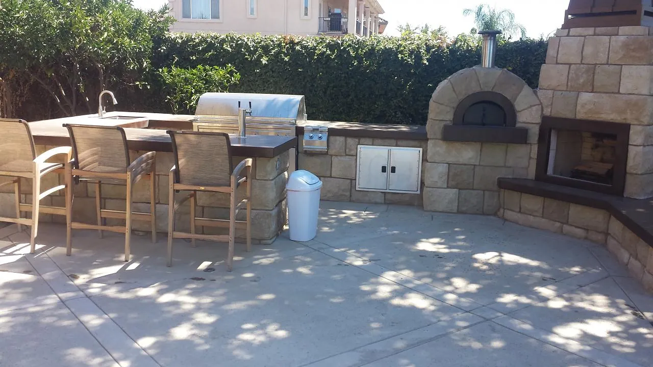 Outdoor kitchen with pizza oven and fireplace by Brickhouse Masonry, Central Valley CA