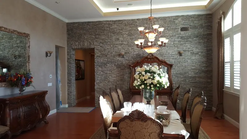 Stone accent wall in a dining room by Brickhouse Masonry, Central Valley CA