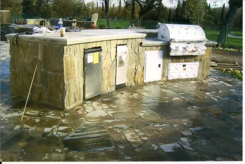 Stone BBQ island on a flagstone patio by Brickhouse Masonry, Central Valley CA