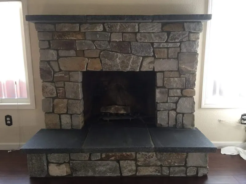 Stone fireplace with slate hearth by Brickhouse Masonry, Central Valley CA