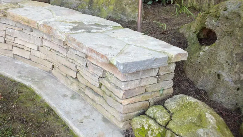 Stone seat wall with flagstone cap by Brickhouse Masonry, Central Valley CA