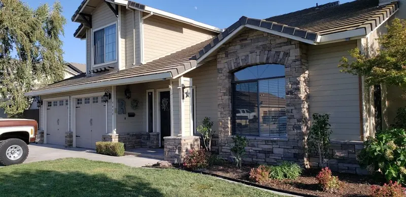 Stone veneer front with arched window by Brickhouse Masonry, Central Valley CA