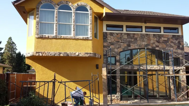 Stone veneer on a two-story exterior by Brickhouse Masonry, Central Valley CA